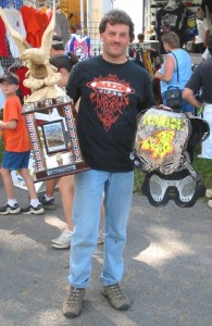 Chris' dad proudly displays what his son accomplished. That's the GNCC Eagle Trophy presented to the Wisp's Overall Winner.