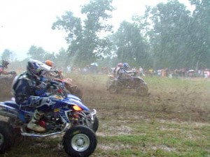The rain was falling hard and Bill Ballance threw caution to the wind as he pulled the holeshot and slid wide in turn one as the rest of the Pro Class was eager right behind him.