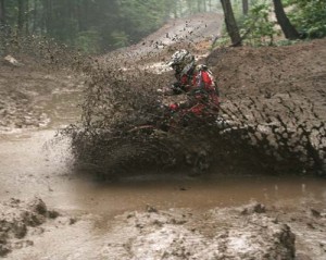 Here a rider splashes through one of the dryer areas of the track.