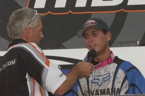 Kory tells new announcer, Rob Whitehead, of his long trip from the back of the pack to the podium.