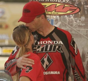 Joe Byrd kisses his four time Women's Class Champion, Heather on the podium. 