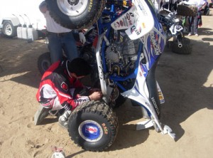 Here Mike Cafro of Temecula Motorsports helps Duncan Racing's Robbie Mitchell adjust the rebound on his rear shock.  Consequently, Cafro finished just a few seconds ahead of Mitchell in the main event. Now Mike, for next time, was that two clicks to the right or two to the left?